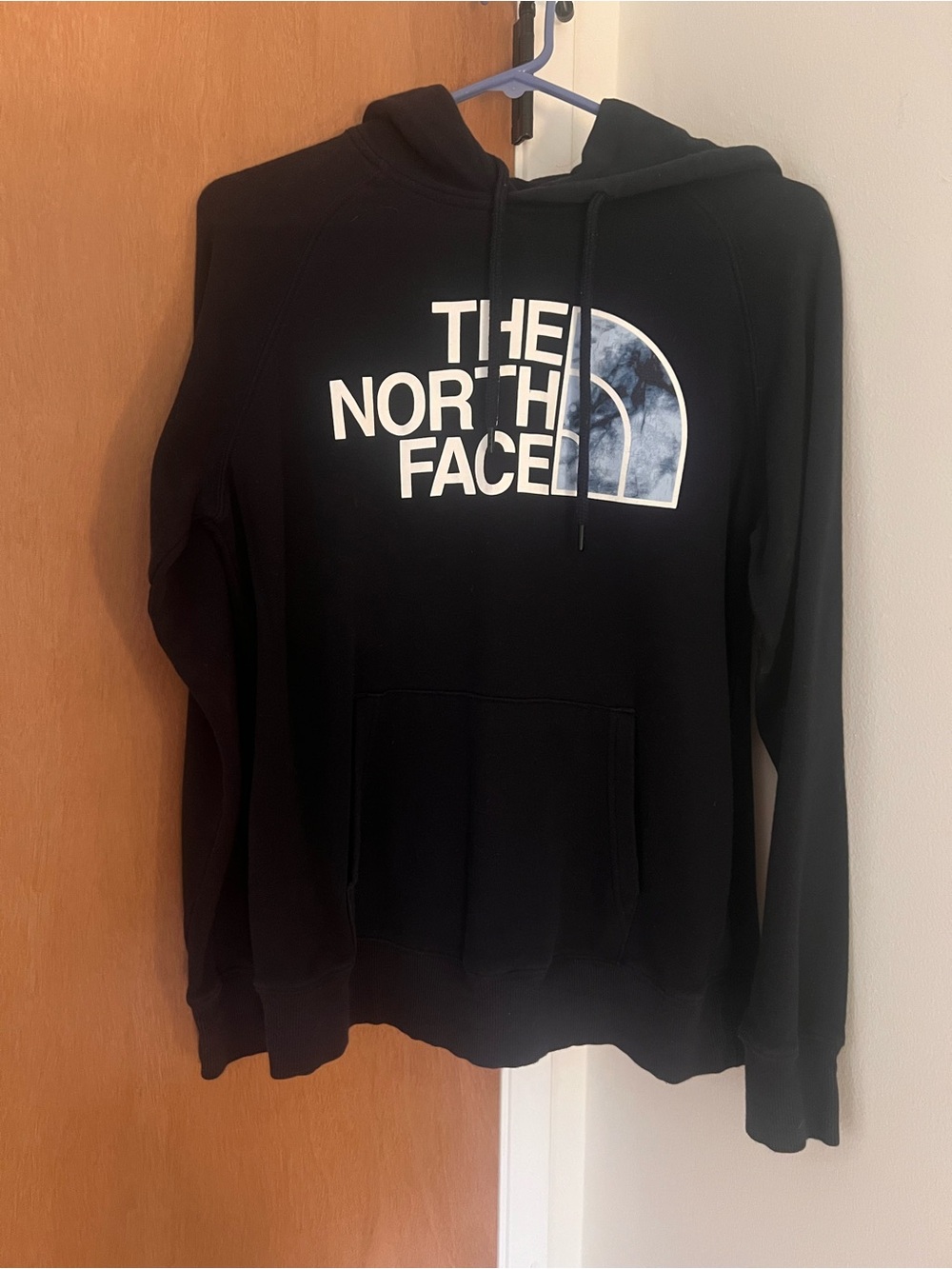 The North Face Black Hoodie with White Logo and Blue-Marble Accent